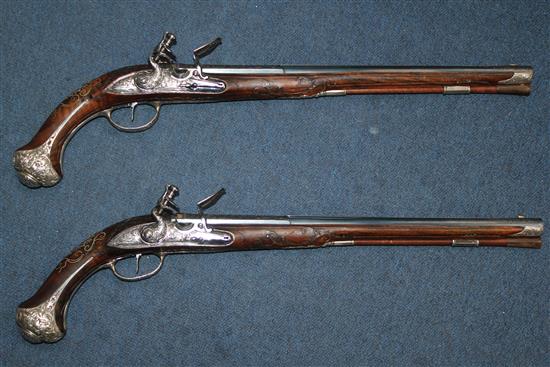 A pair of 18th century Bavarian flintlock holster pistols by Johann Jacob Kuchenreuter, overall length 21.5in.